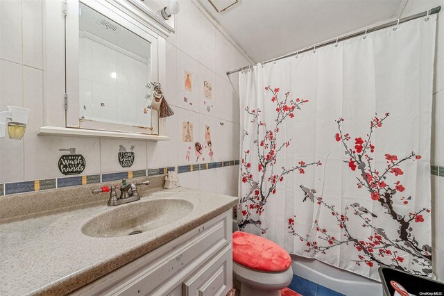 full bathroom with shower / bath combo, vanity, toilet, and tile walls