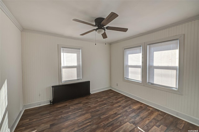 spare room featuring radiator, crown molding, dark wood-type flooring, and ceiling fan