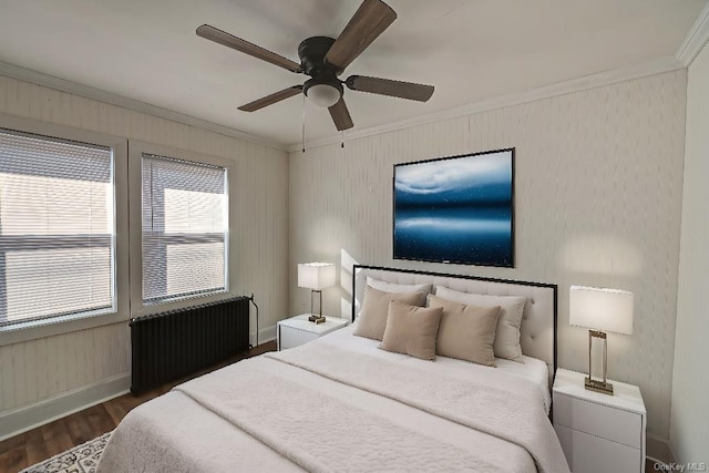 bedroom with ornamental molding, dark wood-type flooring, radiator, and ceiling fan