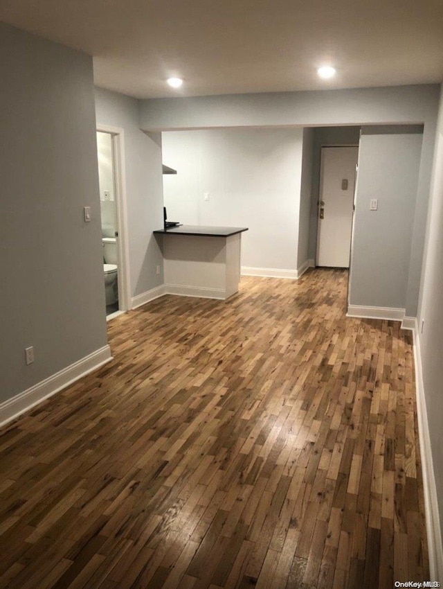 unfurnished living room featuring dark wood-type flooring