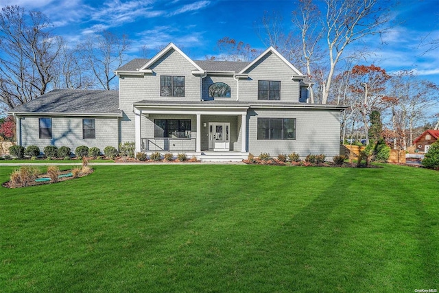 view of front facade featuring covered porch and a front yard