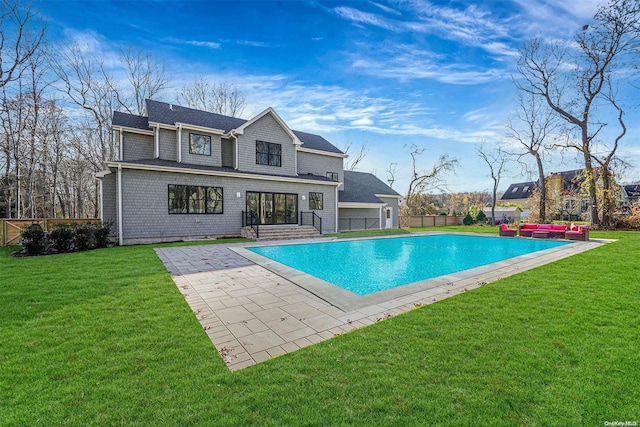 view of pool with a lawn, outdoor lounge area, and a patio