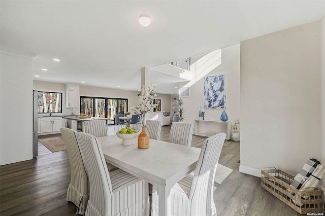 dining area with crown molding and hardwood / wood-style flooring