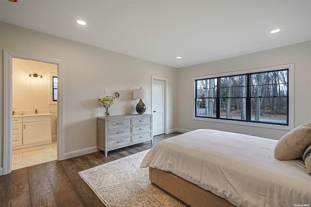 bedroom with dark hardwood / wood-style flooring and ensuite bath