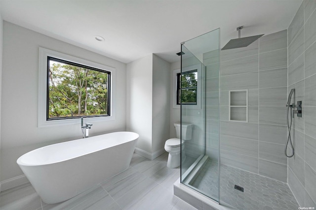 bathroom featuring separate shower and tub and toilet