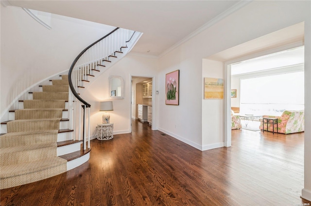 interior space featuring crown molding and dark hardwood / wood-style flooring