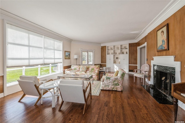 living room with built in shelves, hardwood / wood-style floors, a high end fireplace, and ornamental molding