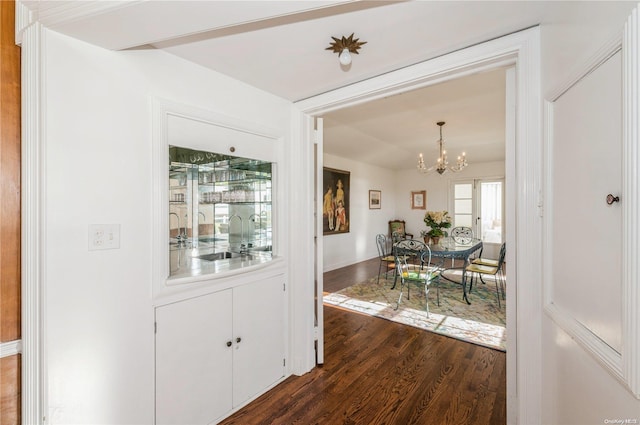 interior space with sink, a chandelier, and dark hardwood / wood-style floors