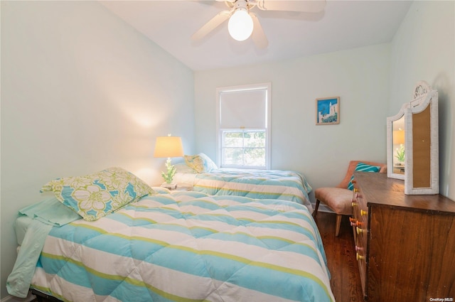 bedroom with hardwood / wood-style flooring, ceiling fan, and lofted ceiling