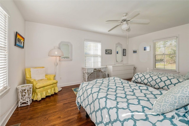 bedroom with multiple windows, ceiling fan, and dark wood-type flooring