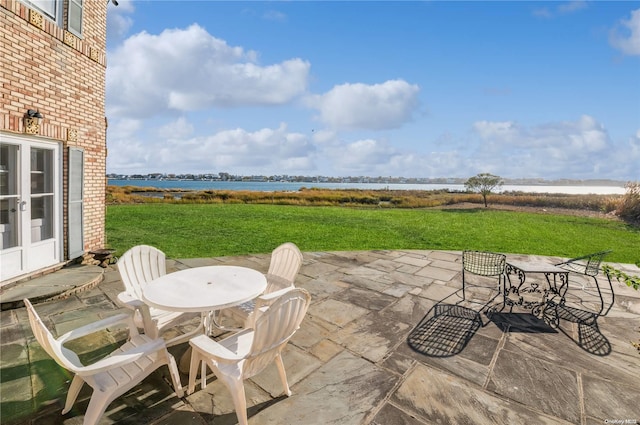 view of patio with a water view and french doors