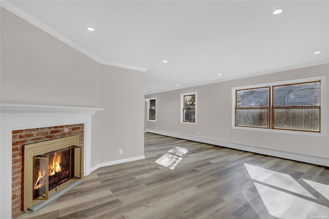 unfurnished living room with light wood-type flooring, a brick fireplace, and ornamental molding