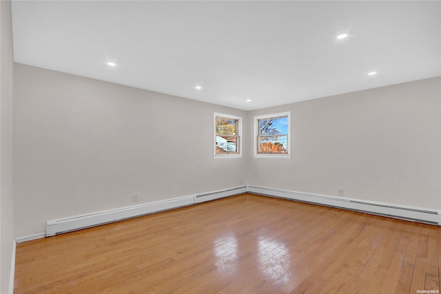 empty room featuring light hardwood / wood-style floors and baseboard heating