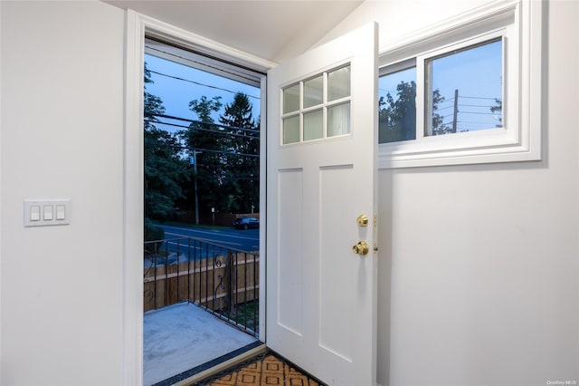 doorway to outside featuring lofted ceiling and parquet floors