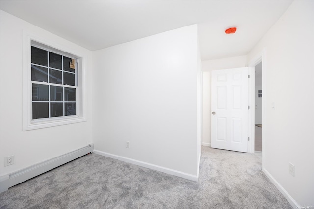 carpeted empty room with baseboard heating