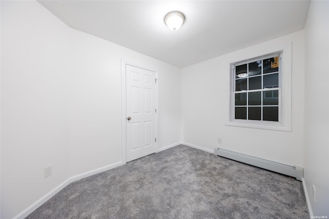 empty room featuring baseboard heating and light carpet