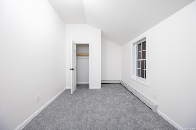 unfurnished bedroom featuring carpet floors, lofted ceiling, and a baseboard heating unit