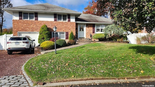 split level home with a front lawn and a garage