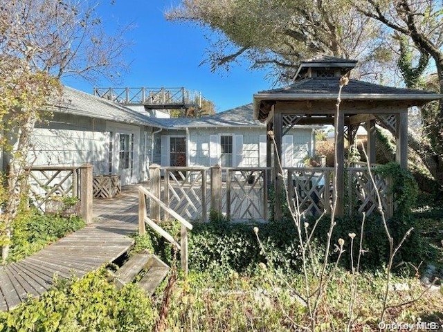 rear view of house featuring a deck