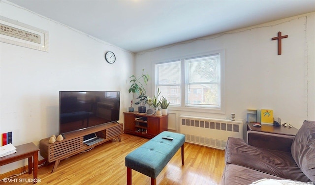 living room featuring radiator heating unit and light hardwood / wood-style floors