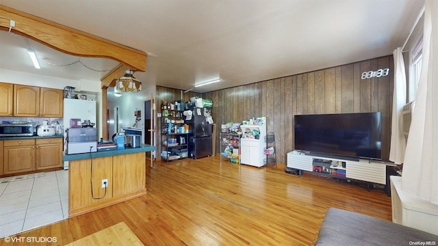 kitchen with wood walls and light hardwood / wood-style floors