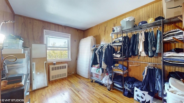 walk in closet with radiator and light hardwood / wood-style flooring