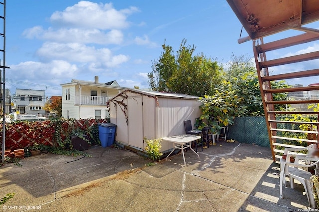 view of patio featuring a storage unit