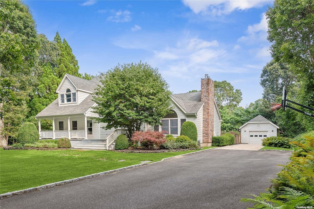 cape cod-style house with an outdoor structure, a front yard, a porch, and a garage