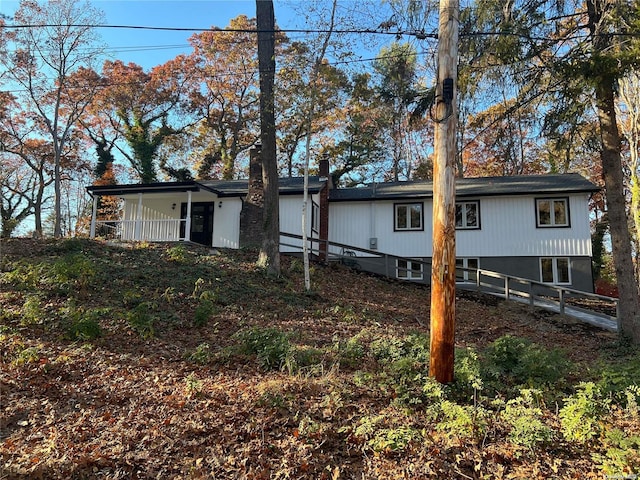 back of house featuring covered porch