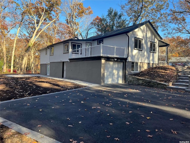 view of home's exterior featuring a garage and a balcony