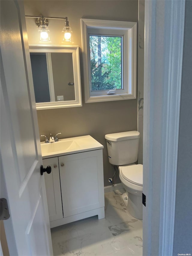 bathroom featuring vanity and toilet