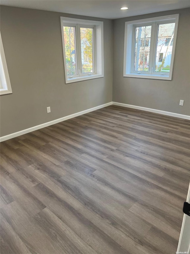 unfurnished room featuring dark hardwood / wood-style floors