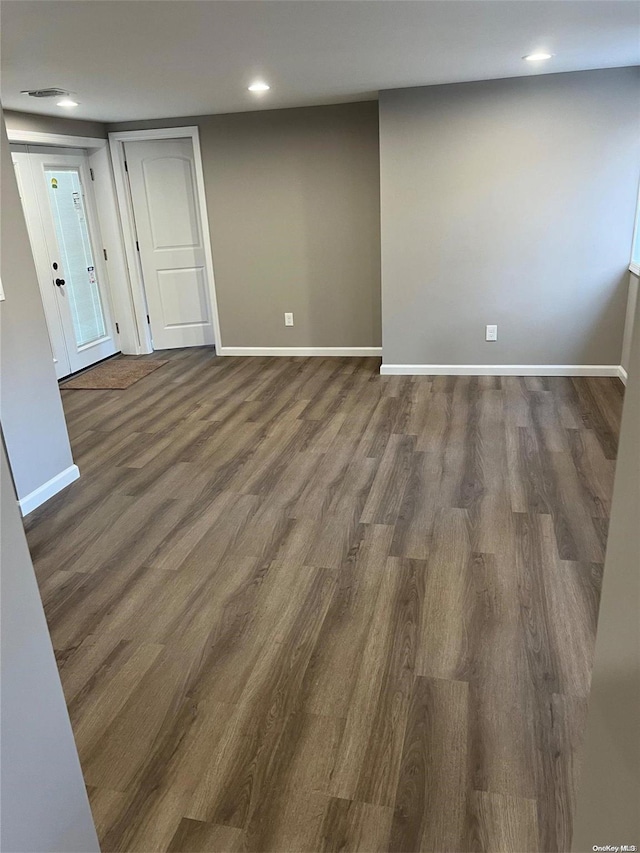 empty room featuring dark wood-type flooring