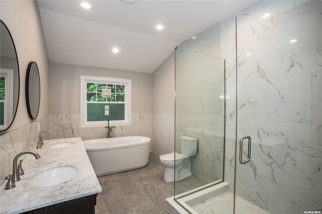 full bathroom featuring vaulted ceiling, toilet, vanity, independent shower and bath, and tile walls