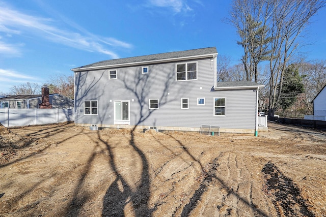 rear view of property featuring fence