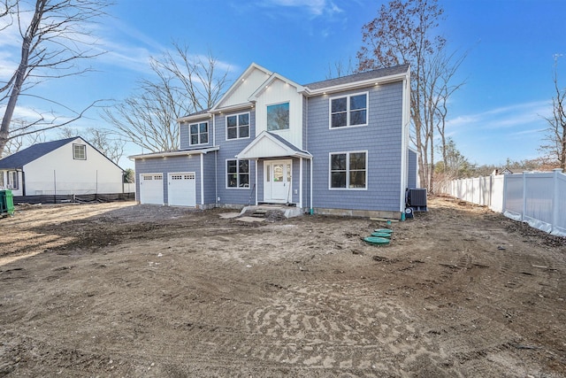 view of front of property with a garage, fence, driveway, and central air condition unit