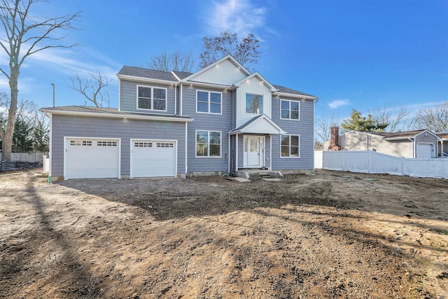 view of front of house featuring driveway and fence