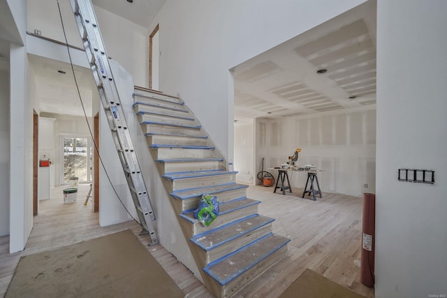 stairs featuring wood finished floors