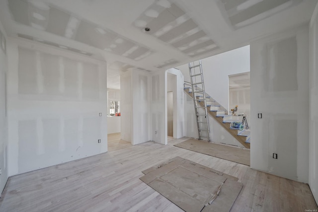 interior space featuring stairway and wood finished floors