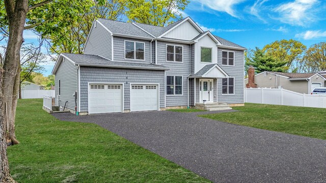 146 Walter Ave, Hauppauge, NY 11788 - traditional-style home with a front lawn, fence, and an attached garage