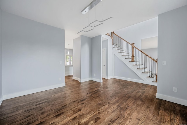 146 Walter Ave, Hauppauge, NY 11788 - unfurnished living room featuring baseboards, stairs, and dark wood-style floors