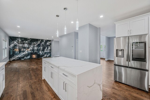 146 Walter Ave, Hauppauge, NY 11788 - kitchen featuring light stone counters, dark wood finished floors, stainless steel fridge, and a center island