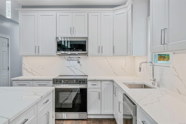 146 Walter Ave, Hauppauge, NY 11788 - kitchen featuring a sink, white cabinets, and appliances with stainless steel finishes