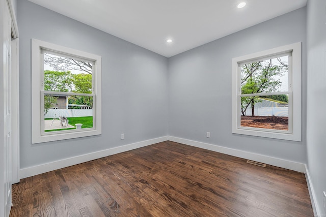146 Walter Ave, Hauppauge, NY 11788 - unfurnished room with baseboards, dark wood-type flooring, and visible vents