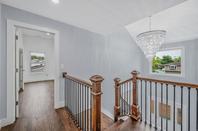 146 Walter Ave, Hauppauge, NY 11788 - hall featuring baseboards, an upstairs landing, a chandelier, and wood finished floors