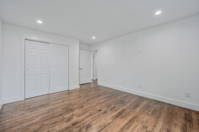 146 Walter Ave, Hauppauge, NY 11788 - unfurnished bedroom featuring baseboards, a closet, recessed lighting, and wood finished floors