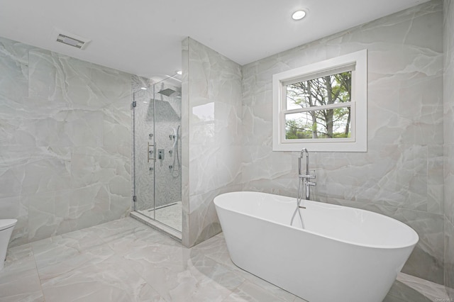 146 Walter Ave, Hauppauge, NY 11788 - full bath with tile walls, a marble finish shower, marble finish floor, and a freestanding tub