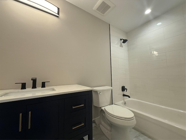 full bathroom featuring toilet, tiled shower / bath, and vanity