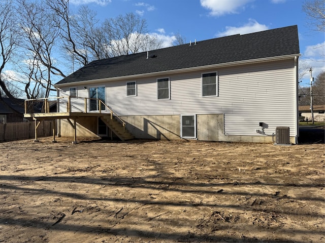 rear view of house featuring a wooden deck and cooling unit