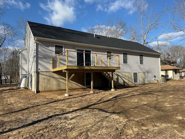 rear view of property with a wooden deck and central air condition unit